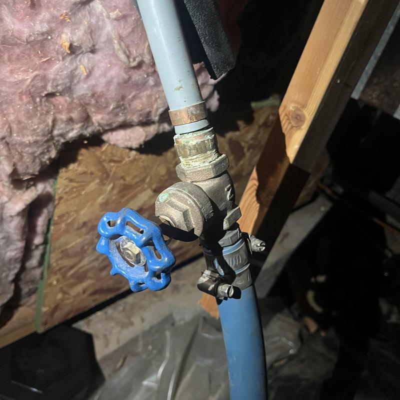 Gate valve with blue handle on water supply pipe
