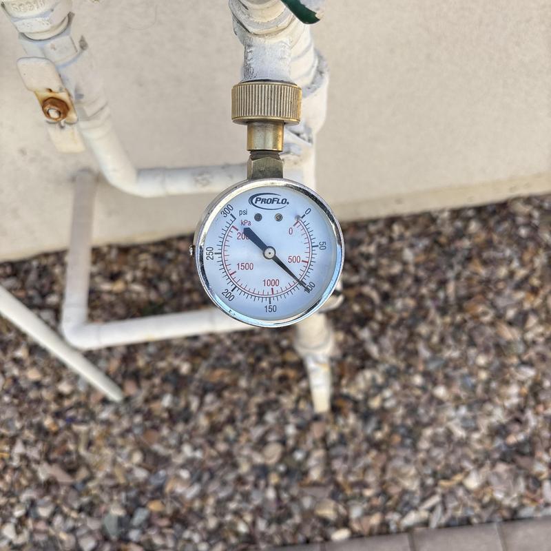 Pressure regulator valve with attached gauge on pipe Pressure regulator valve with attached gauge on pipe