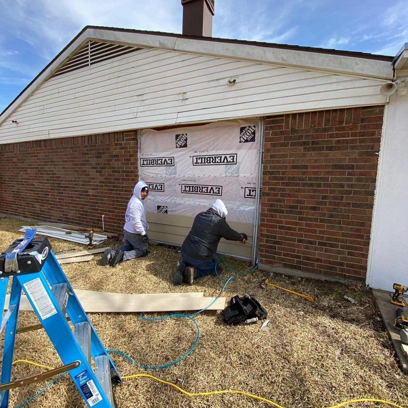 LP SmartSide siding installation on brick house wall
