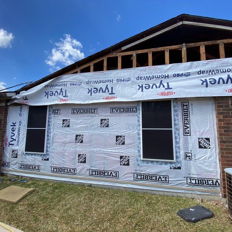 House wrap installation on exterior wall with windows