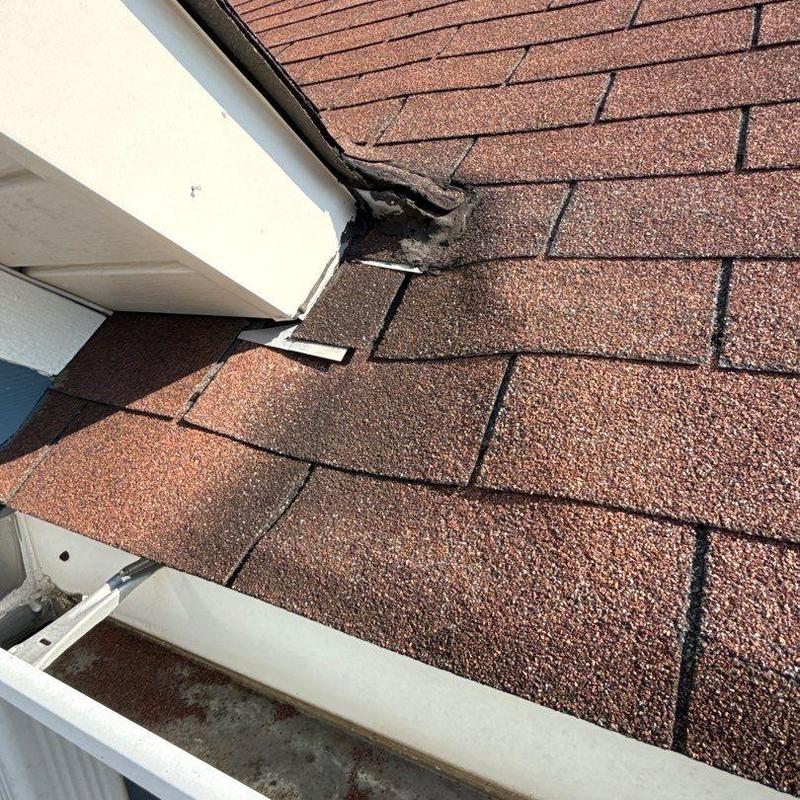 Asphalt shingles near flashing with hail damage