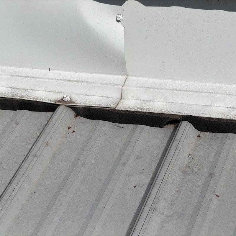 Metal roof flashing with hail damage and wear