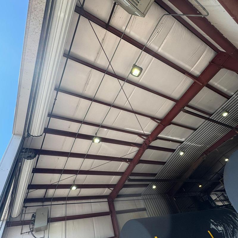 Metal roof panels and insulation with lighting fixtures