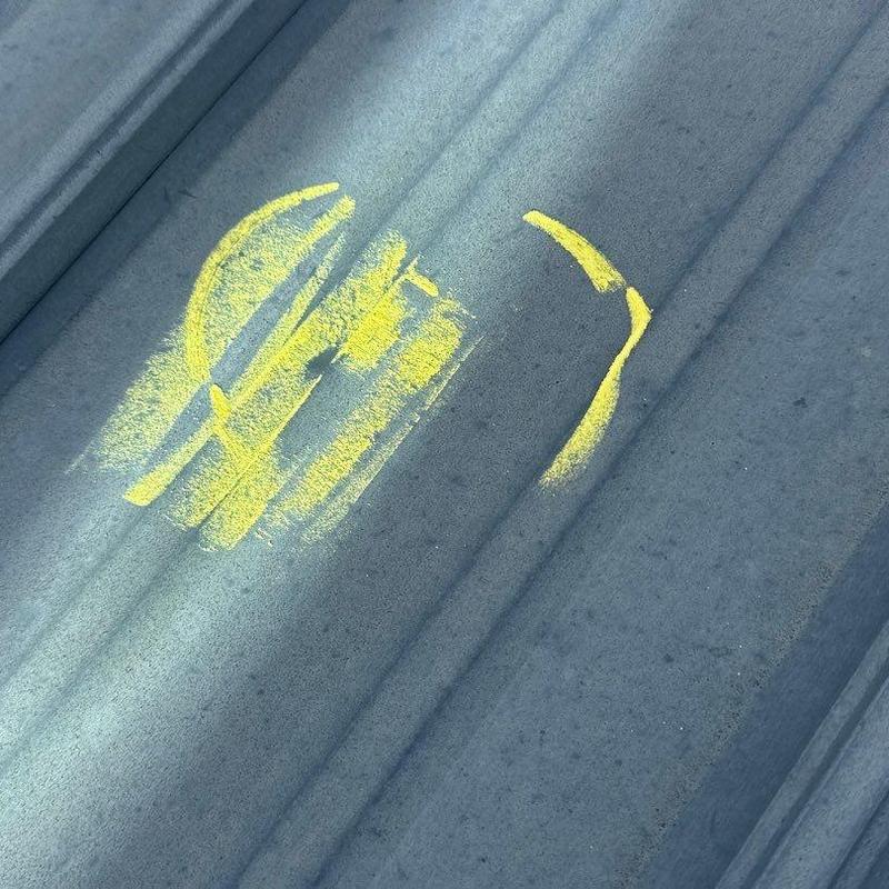 Metal roofing hail damage marked with yellow paint