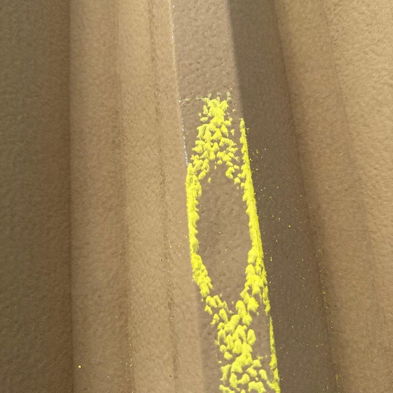 Metal roofing panel hail damage marked with yellow chalk