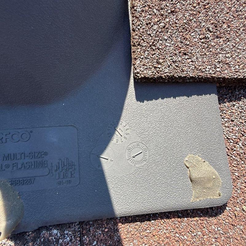 Roof flashing with hail damage on asphalt shingles