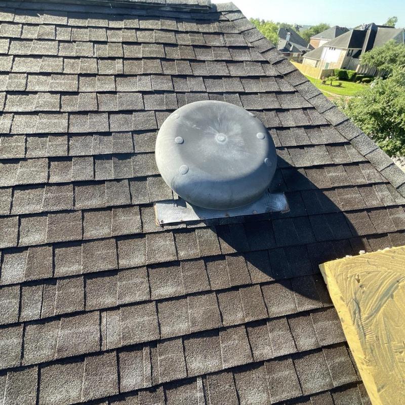 Roof vent flashing with new shingles on asphalt roof