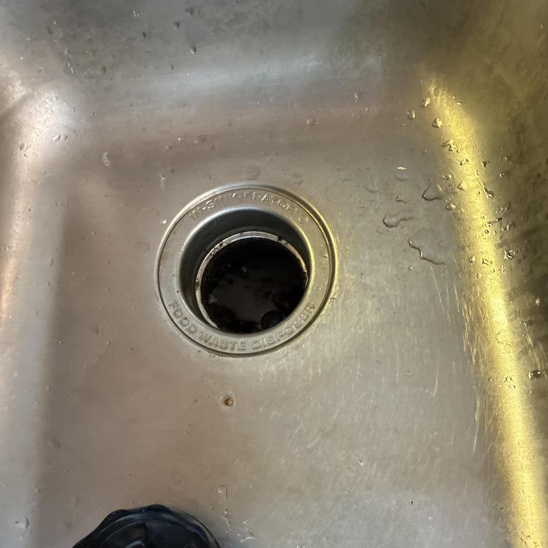 Garbage disposal drain opening in stainless steel sink