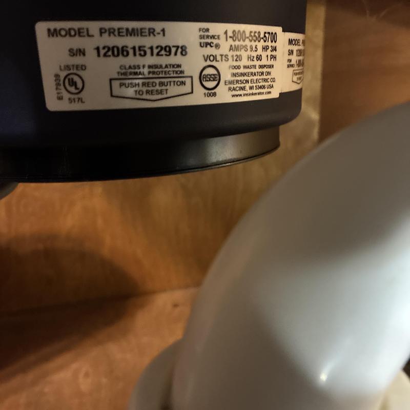 Garbage disposal unit label and drain pipe under sink
