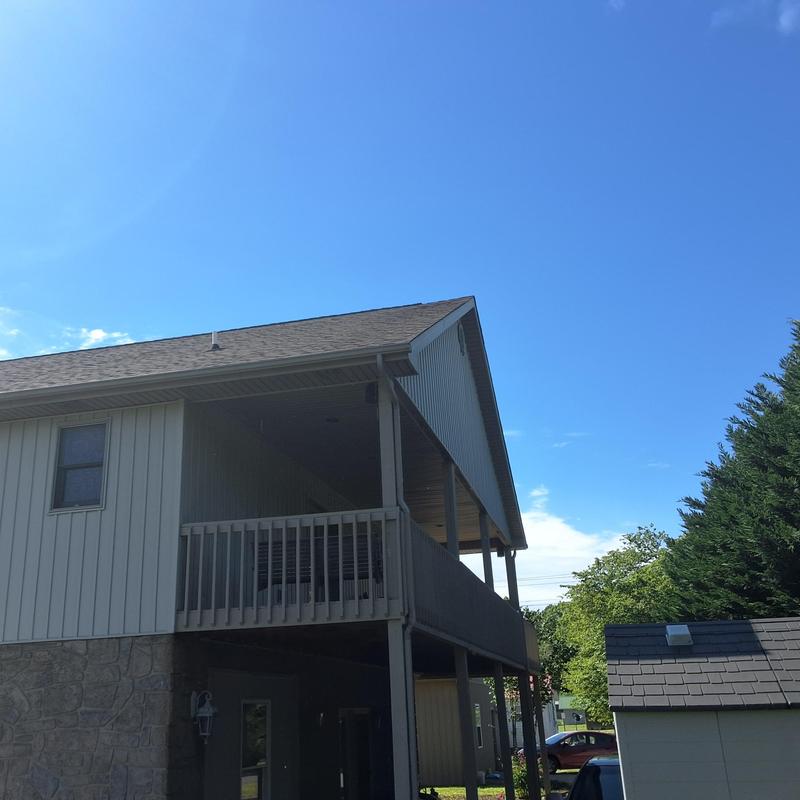 Roof shingles and siding with balcony railing view Roof shingles and siding with balcony railing view
