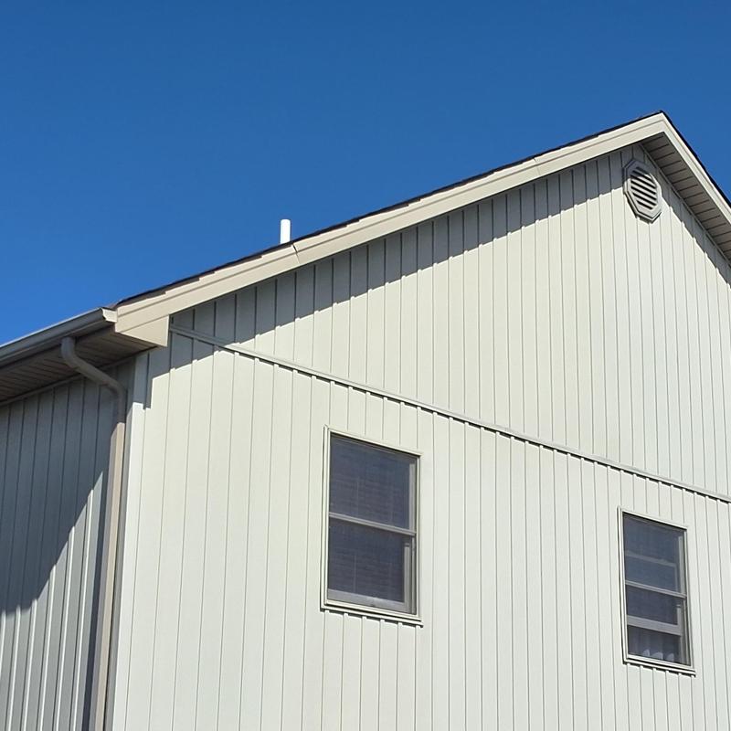 Roof fascia and siding on residential home under clear sky Roof fascia and siding on residential home under clear sky
