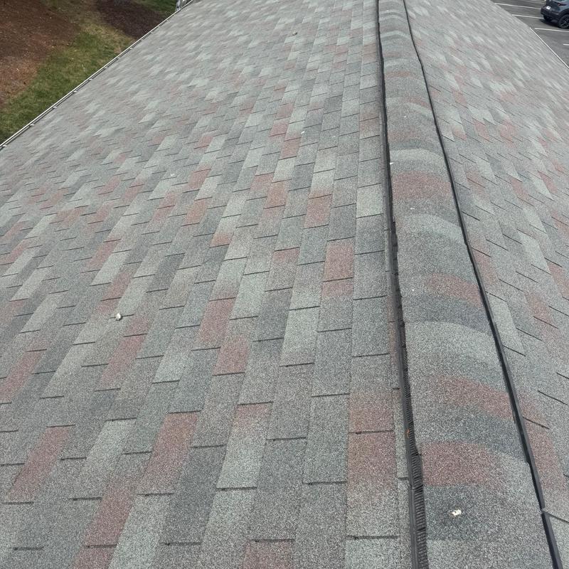 Asphalt shingle roof ridge with venting detail