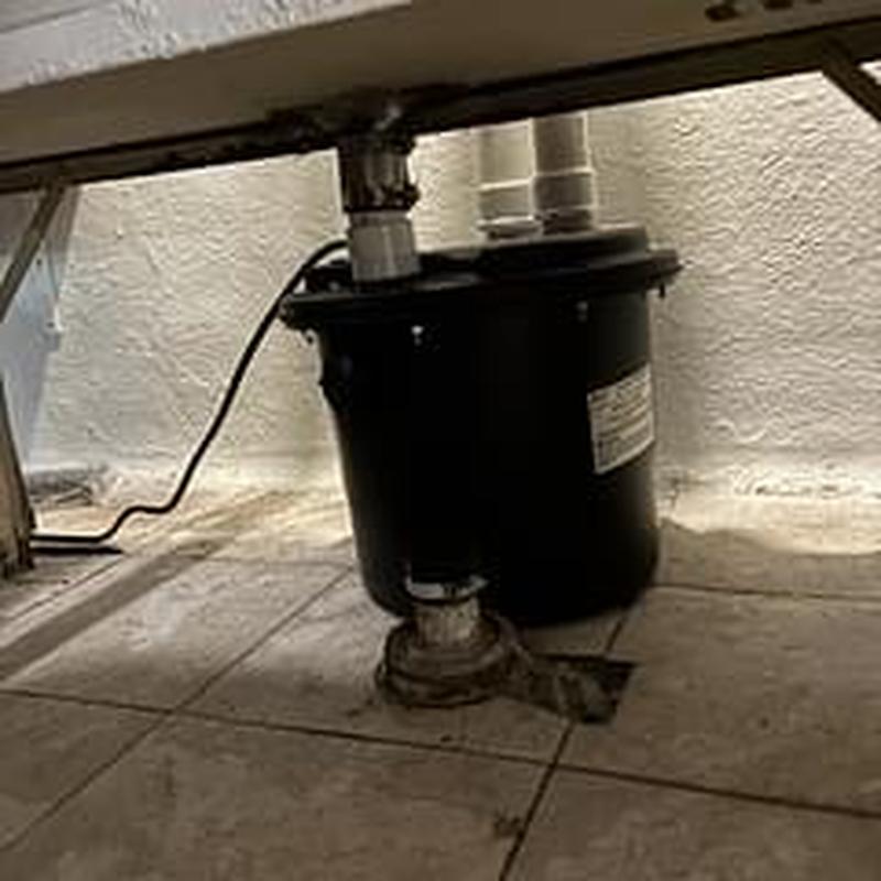 Sump pump system installation under basement sink