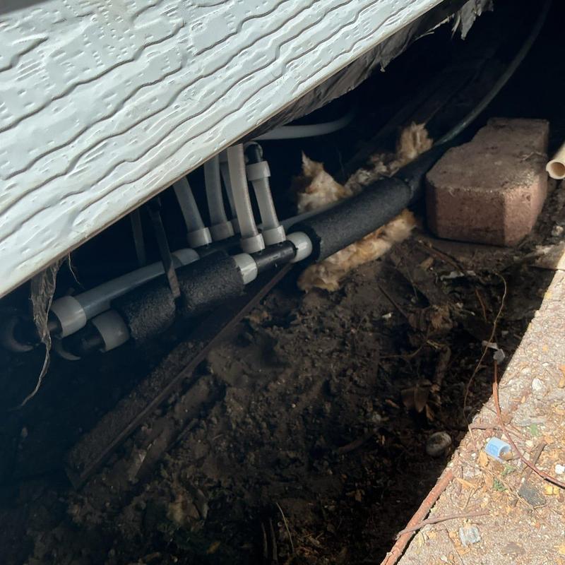 Uponor PEX A piping under mobile home exterior wall