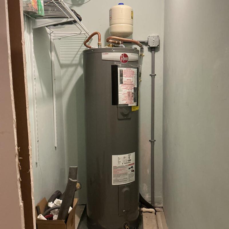 Rheem electric water heater installed in utility room