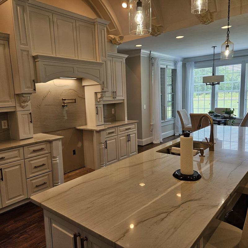 Marble kitchen island with sink and lighting fixtures