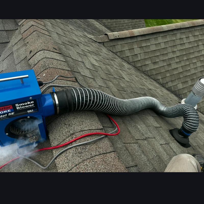 Vent pipe smoke testing on shingled roof