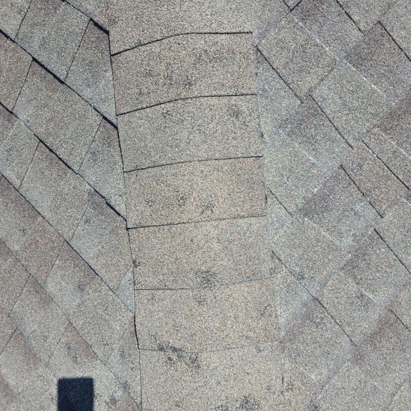 Asphalt shingle roof with hail damage impact marks