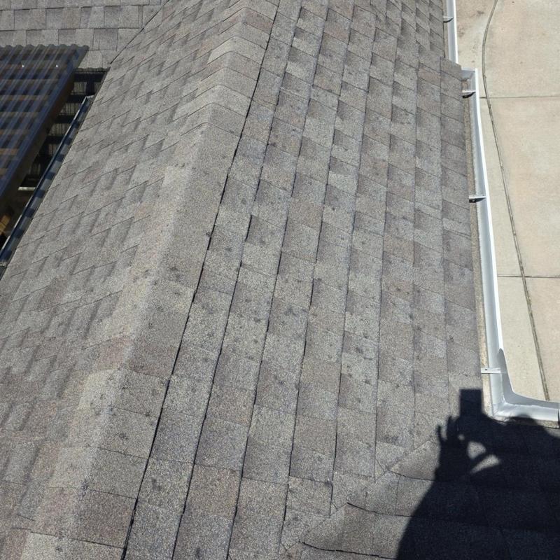 Asphalt shingle roof with hail damage impact marks