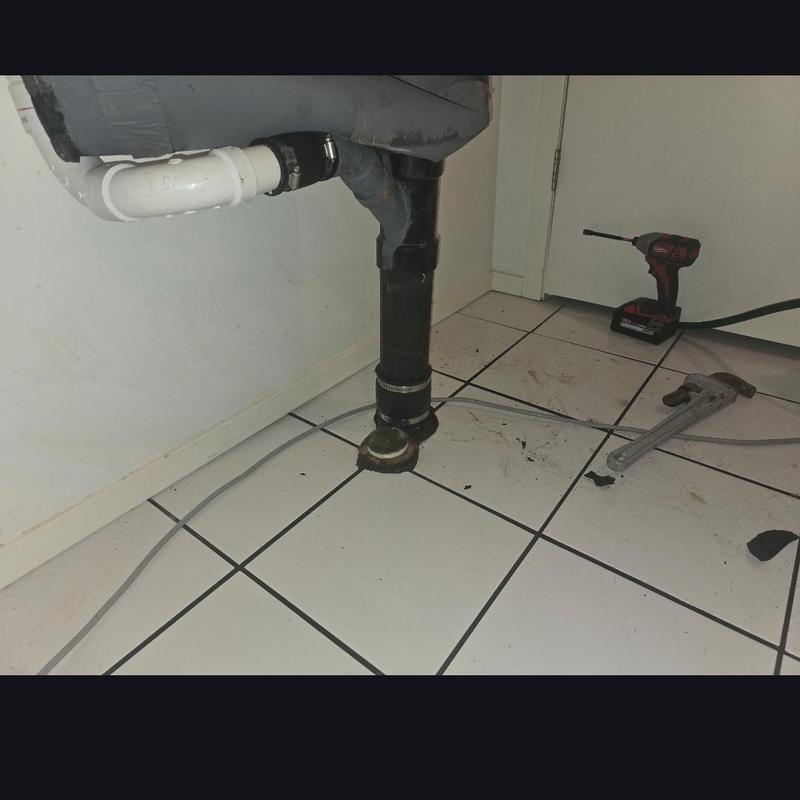 Drain pipe with clog cleared 25ft out and tools nearby