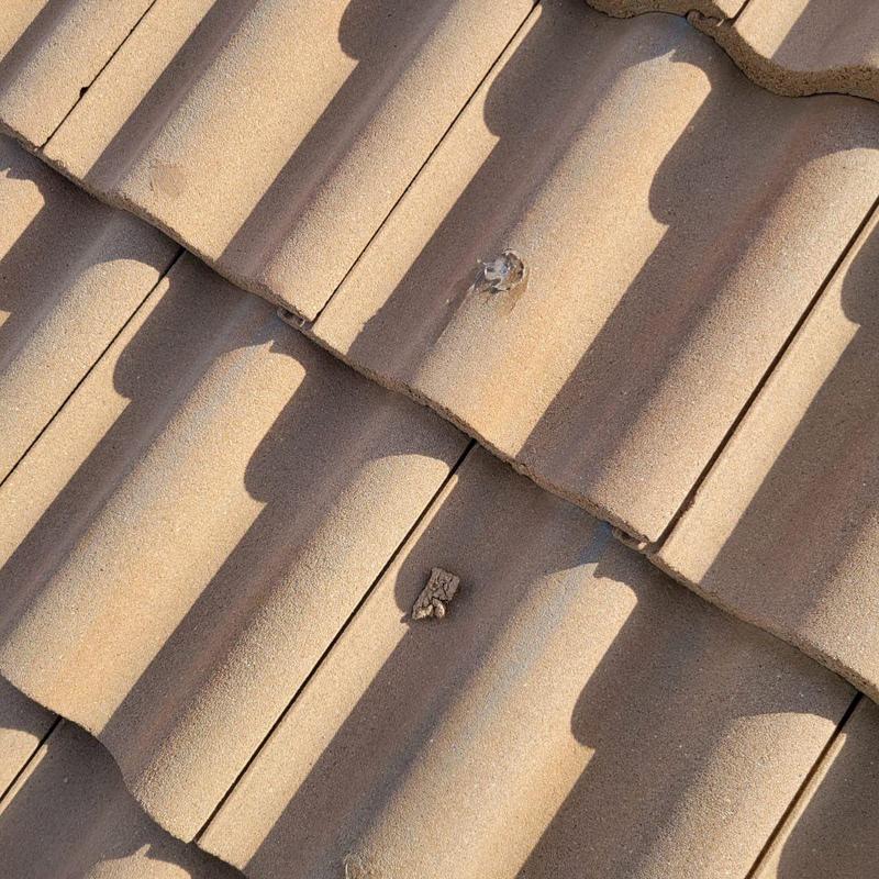 Concrete tile roof with patched penetration holes