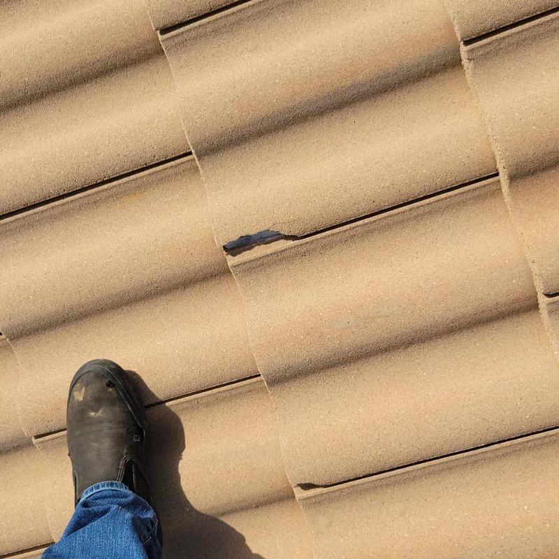 Concrete tile with cracks and damaged areas on roof