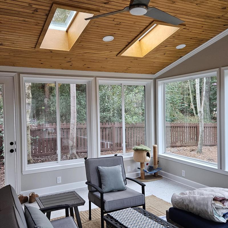 Wooden vaulted ceiling with skylights and ceiling fan