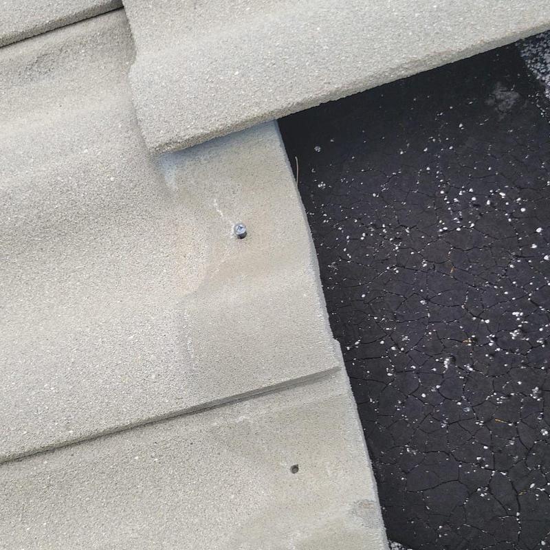Concrete tile roof with cracked underlayment and damaged tiles