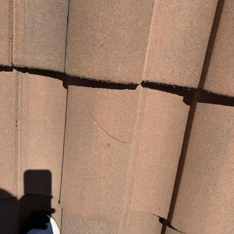 Concrete tile roof with cracked and slipping tiles