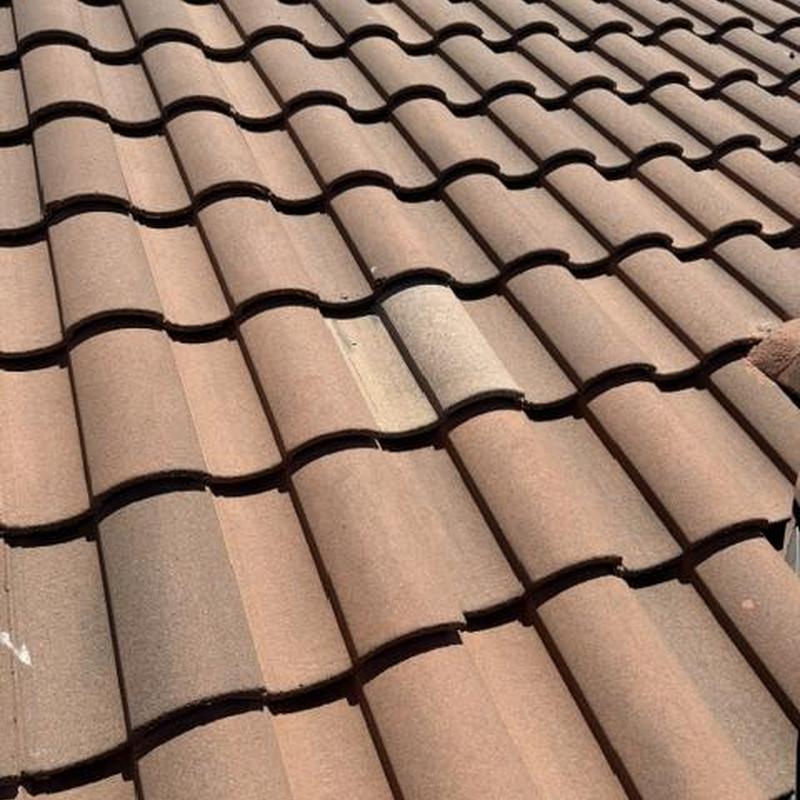 Concrete tile roof with broken and slipping tiles