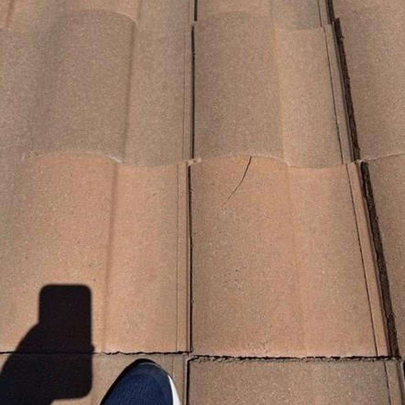 Concrete tile roof with visible crack and wear