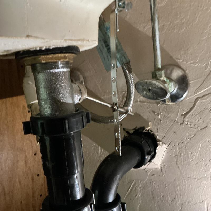 P-trap plumbing installation under sink in textured wall P-trap plumbing installation under sink in textured wall