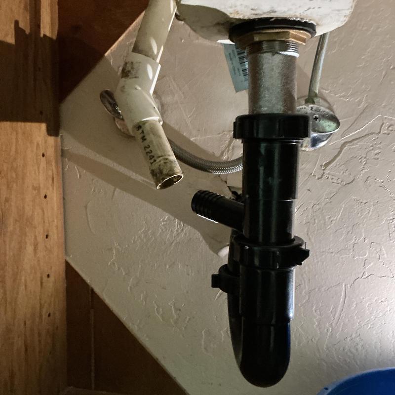 P-trap installation under sink with supply pipe visible P-trap installation under sink with supply pipe visible