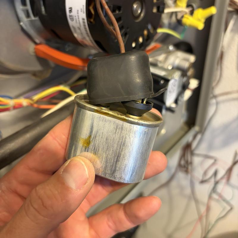 HVAC inducer motor run capacitor with leak