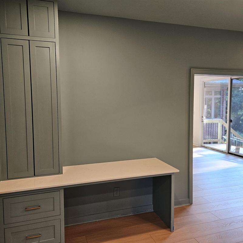 Built-in gray cabinetry with desk and hardwood flooring