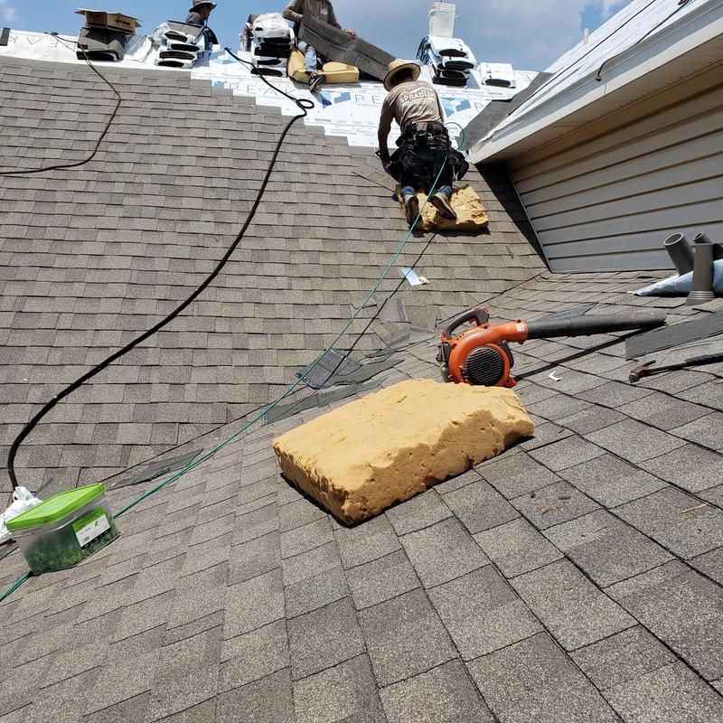 GAFHDZ asphalt shingles on roof with workers GAFHDZ asphalt shingles on roof with workers