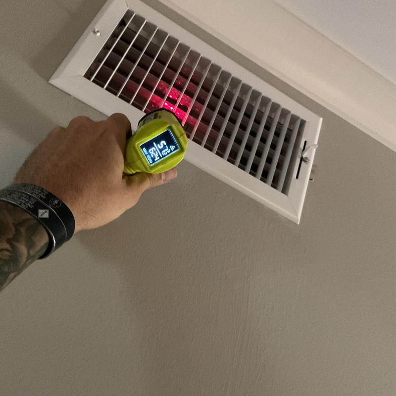 Air vent temperature checked with infrared thermometer
