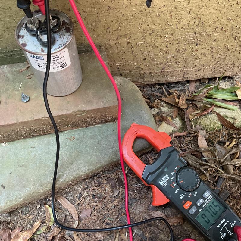 AC capacitor testing with clamp meter outdoors