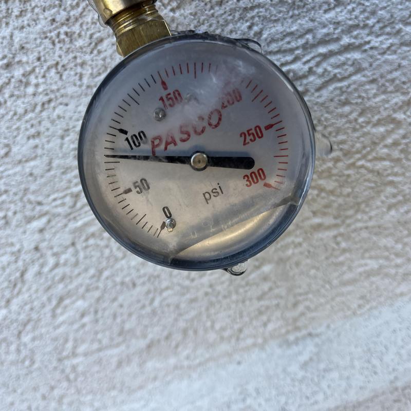 Water pressure gauge on outdoor plumbing line