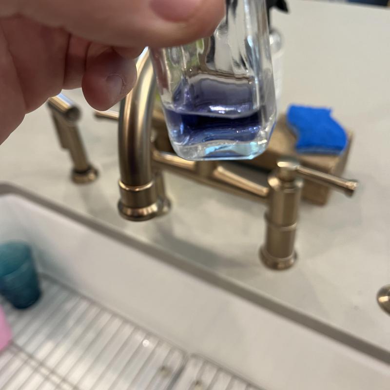 Water softener test solution near brass faucet handles