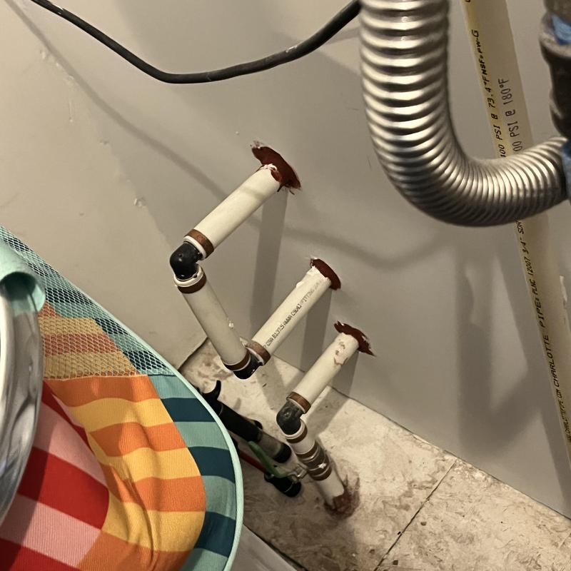 Water softener plumbing pipes with wall penetrations