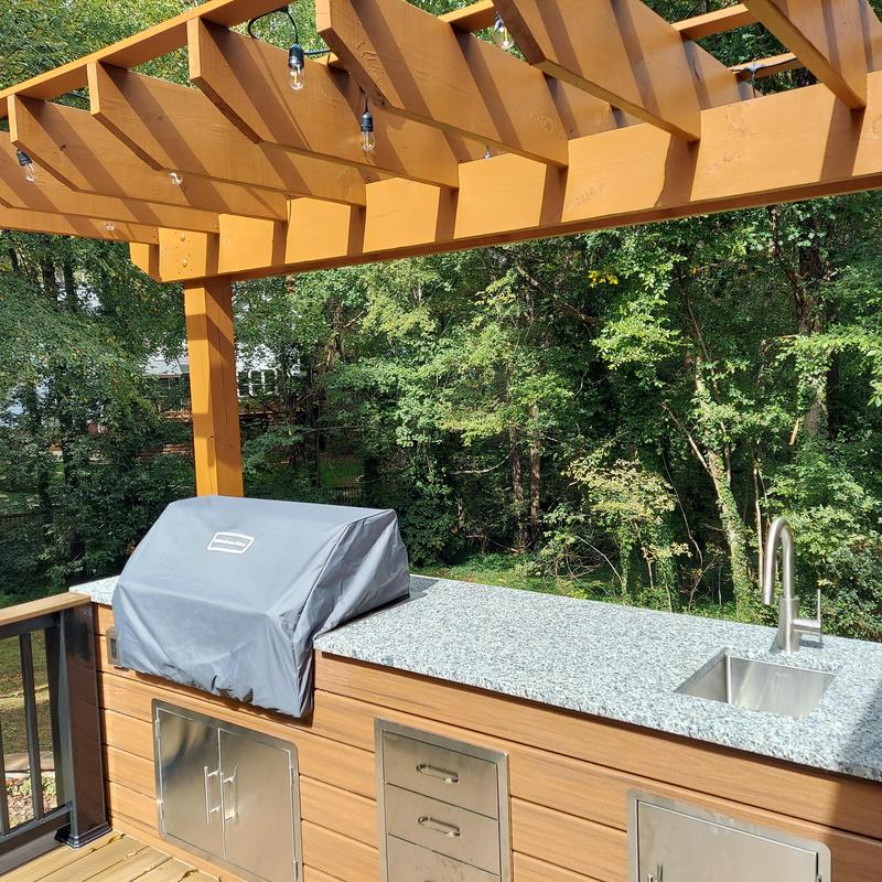 Outdoor kitchen countertop with sink and covered grill