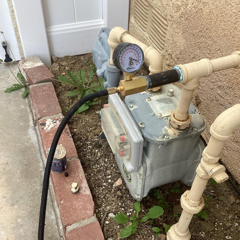 Gas line pressure gauge attached to meter panel