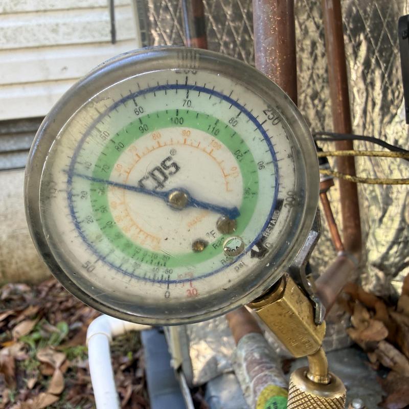 AC pressure gauge on refrigerant line outdoors AC pressure gauge on refrigerant line outdoors