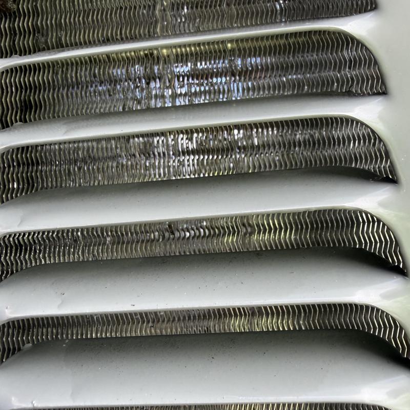 Outdoor HVAC condenser coil with dirt buildup