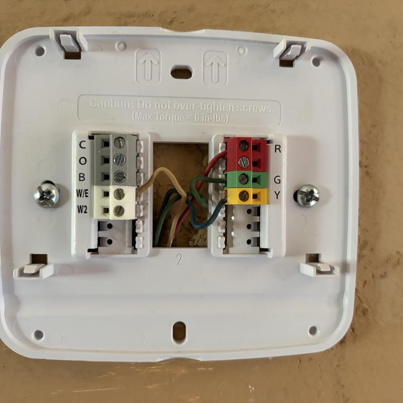 Thermostat wiring connections in HVAC system panel
