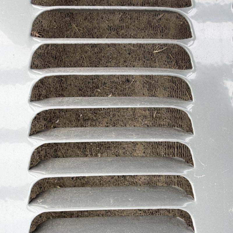 Outdoor HVAC condenser coil with dirt buildup