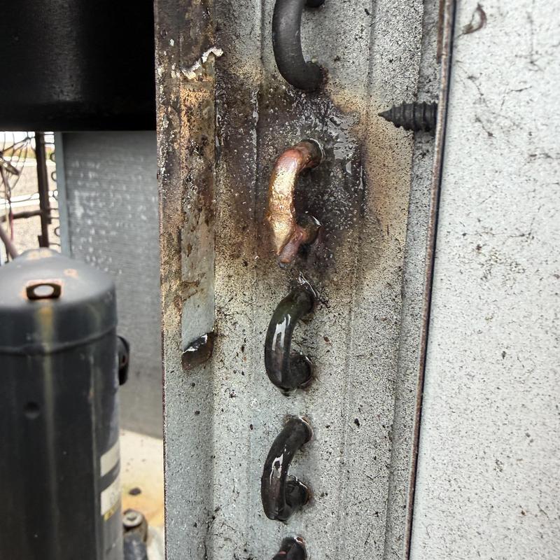 Copper coil leak on HVAC unit with visible damage