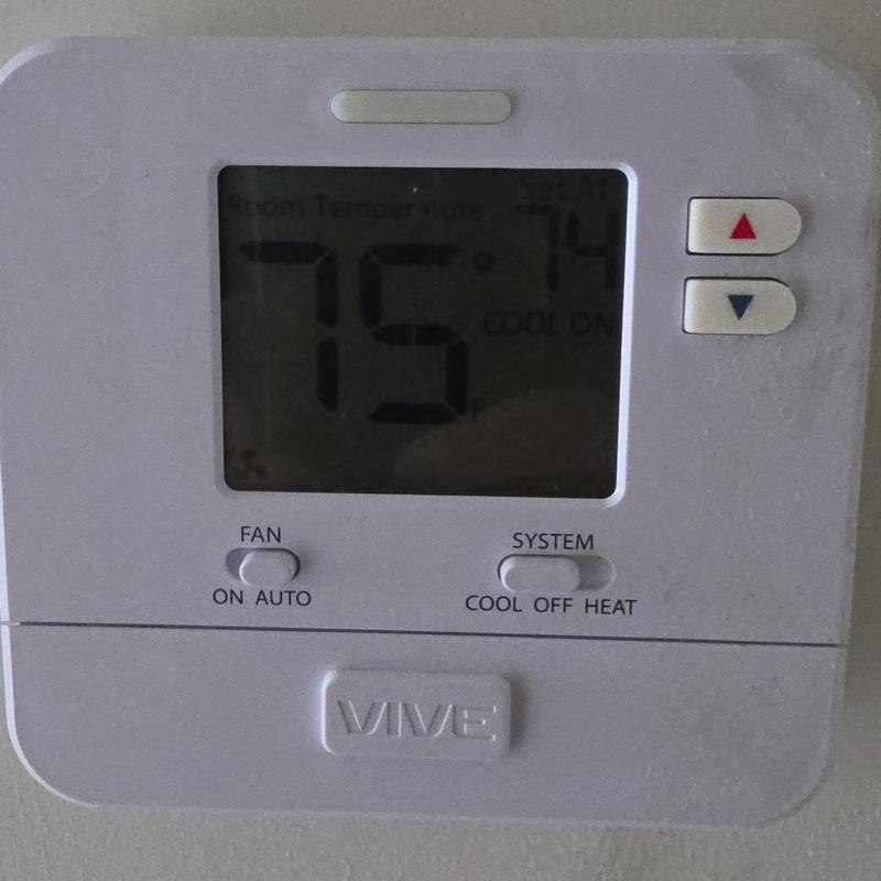 Thermostat display showing temperature and mode settings