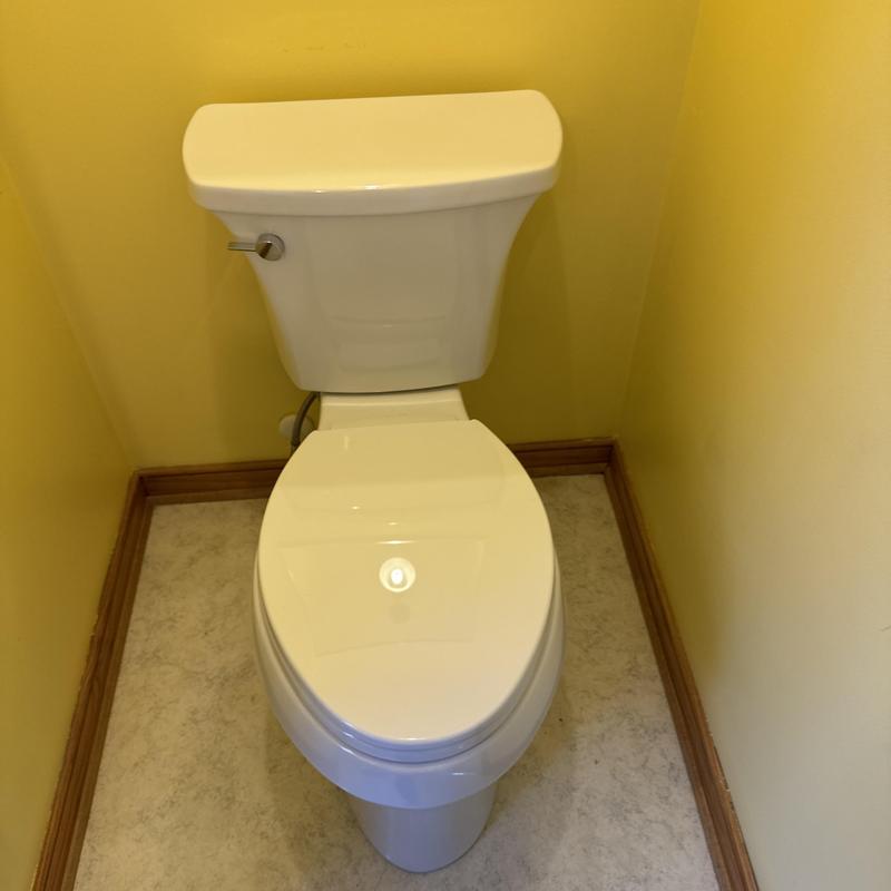 Kohler toilet installed in yellow bathroom corner Kohler toilet installed in yellow bathroom corner